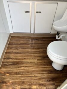 A clean small bathroom featuring a toilet and sink, professionally cleaned by Treadway's Cleaning Services in Spencer, IN