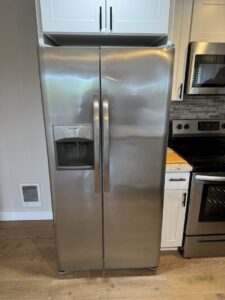 A clean stainless steel side-by-side refrigerator after professional cleaning by Nannie Needs LLC in Kent, WA.