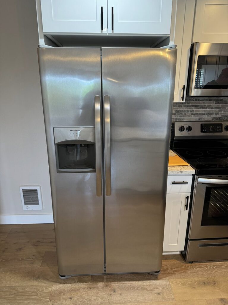 A clean stainless steel side-by-side refrigerator after professional cleaning by Nannie Needs LLC in Kent, WA.