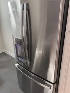 A polished stainless steel refrigerator, reflecting the meticulous appliance cleaning by JBO Cleaning Services in Belle Chasse, LA.