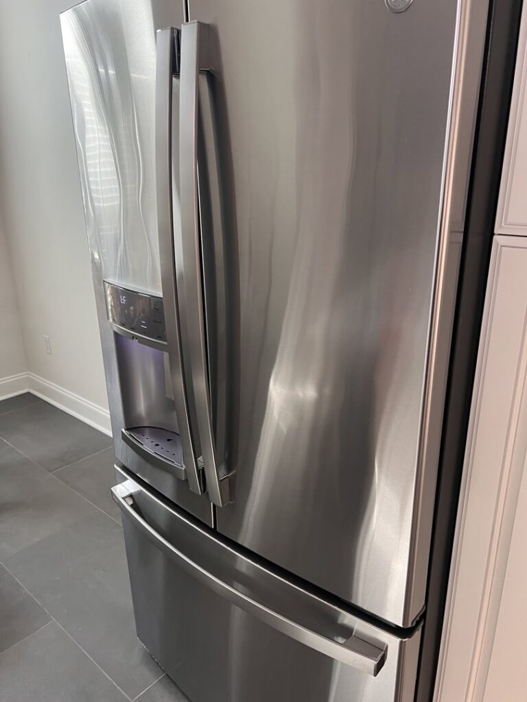 A polished stainless steel refrigerator, reflecting the meticulous appliance cleaning by JBO Cleaning Services in Belle Chasse, LA.