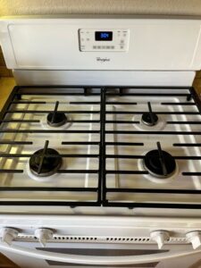 A gleaming stainless steel stove top, thoroughly cleaned by Sage & Soap Cleaning Co in Kansas City, MO.