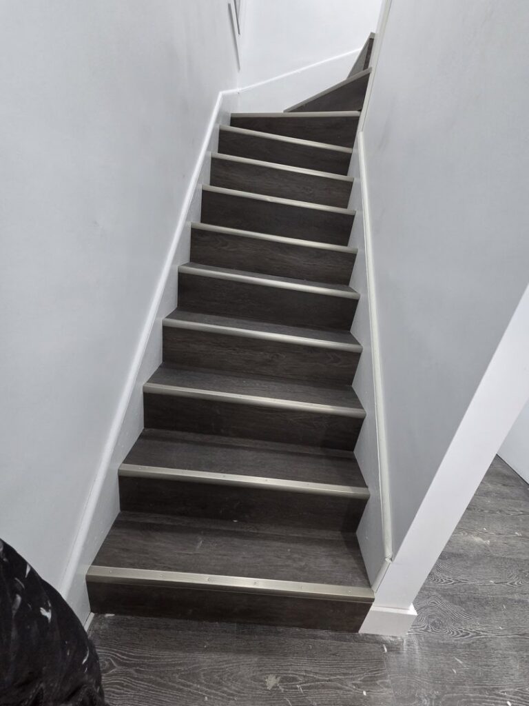 A clean staircase with dark wood steps after professional house cleaning by Hm General Cleaning Services in Schenectady, NY
