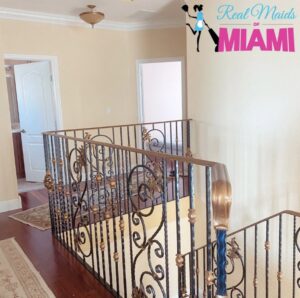 A clean staircase and upper hallway in a residential home, cleaned by Real Maids of Miami, LLC in Miami, FL.