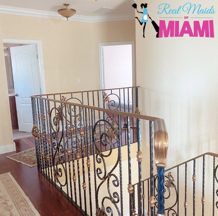 A clean staircase and upper hallway in a residential home, cleaned by Real Maids of Miami, LLC in Miami, FL.