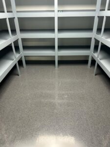 A clean storage room with empty shelves and a tidy floor, maintained by Green Leaf Janitorial in Gilbert, AZ.
