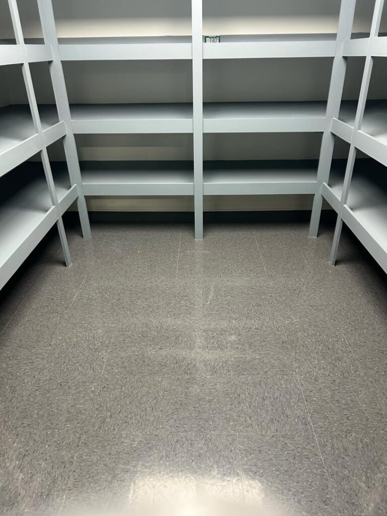 A clean storage room with empty shelves and a tidy floor, maintained by Green Leaf Janitorial in Gilbert, AZ.