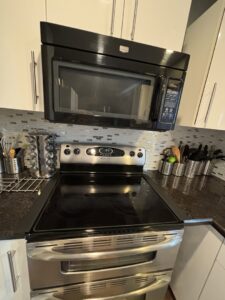 A close-up of a spotless stove top and microwave, cleaned by Cleaning Service Masters LLC in Escondido, CA