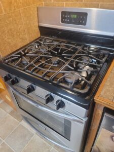 A sparkling clean stove top and oven, showcasing the detailed kitchen cleaning by Rita's cleaning in Fort Worth, TX.