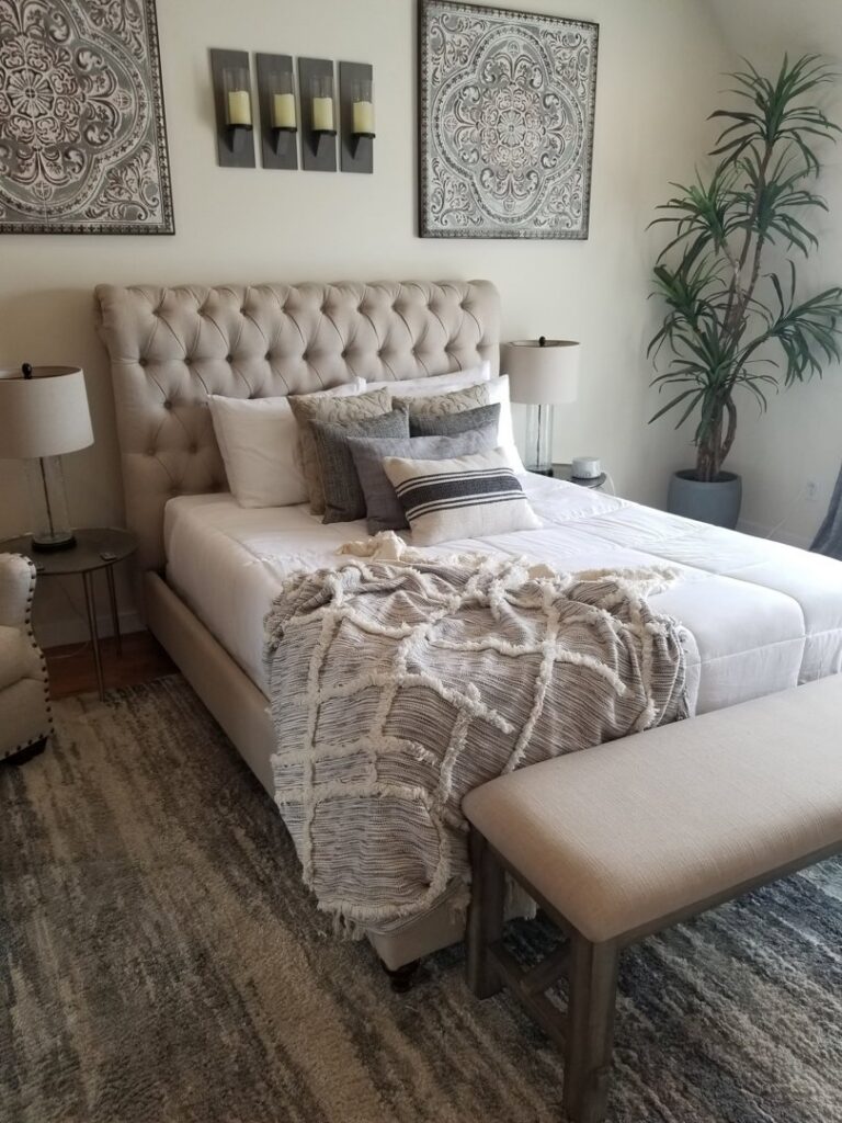 A clean and tidy bedroom with a made bed and decorative pillows by Cooper-N-Folks in Philadelphia, PA