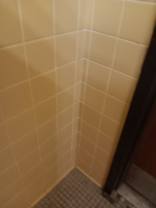 A clean tiled bathroom wall, reflecting the thorough cleaning provided by Janice Janitorial LLC in Baton Rouge, LA.
