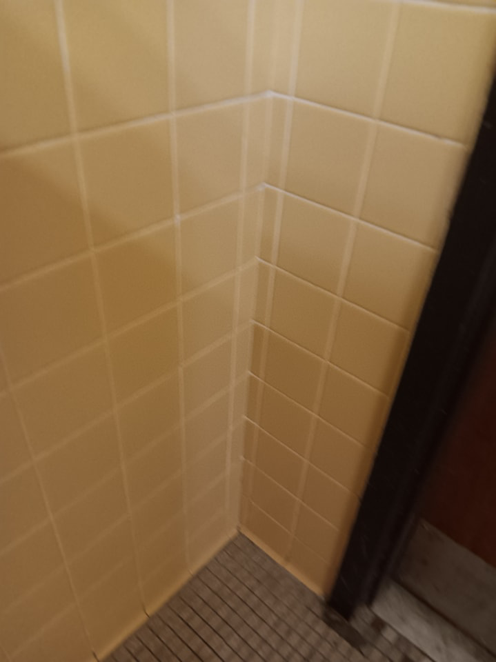 A clean tiled bathroom wall, reflecting the thorough cleaning provided by Janice Janitorial LLC in Baton Rouge, LA.