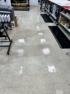 A clean tiled floor in a commercial space, reflecting light after janitorial services by Green Leaf Janitorial in Gilbert, AZ.