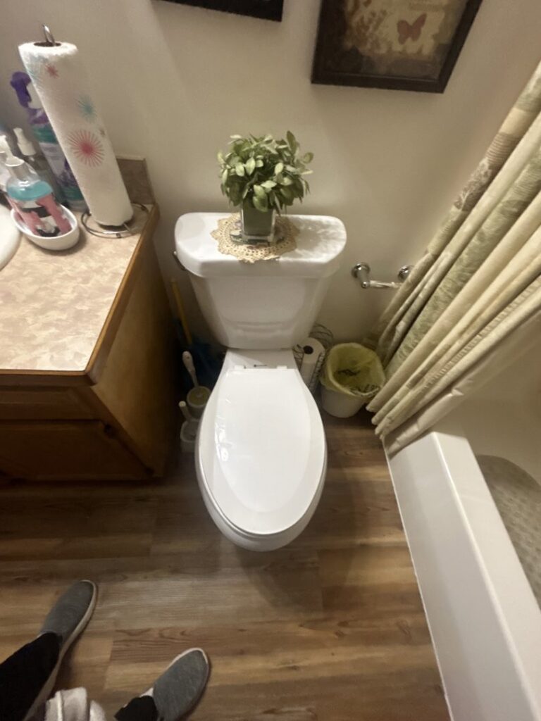 A clean toilet and sparkling bathroom floor, demonstrating the thorough cleaning services of Wilkie Wonders Cleaning in Akron, OH.
