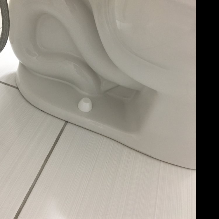 The meticulously clean base of a toilet in a bathroom, cleaned by Magic Maids in Bremen, AL.