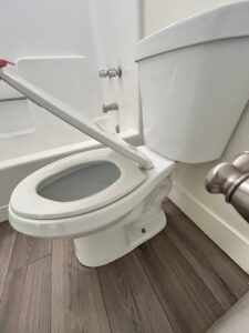 A sparkling clean toilet in a bathroom, ready for use after a professional cleaning by Carole's House Cleaning in Tempe, AZ.