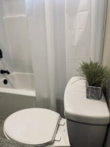 A clean toilet and tidy bathroom area, reflecting the thorough cleaning services of Sudz Up Cleaning Company in Columbia, MO.