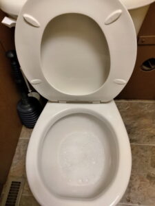 A clean toilet bowl with fresh bubbles, showing the results of a thorough cleaning service by CleanSlate Cleaning Company in Lansing, MI.