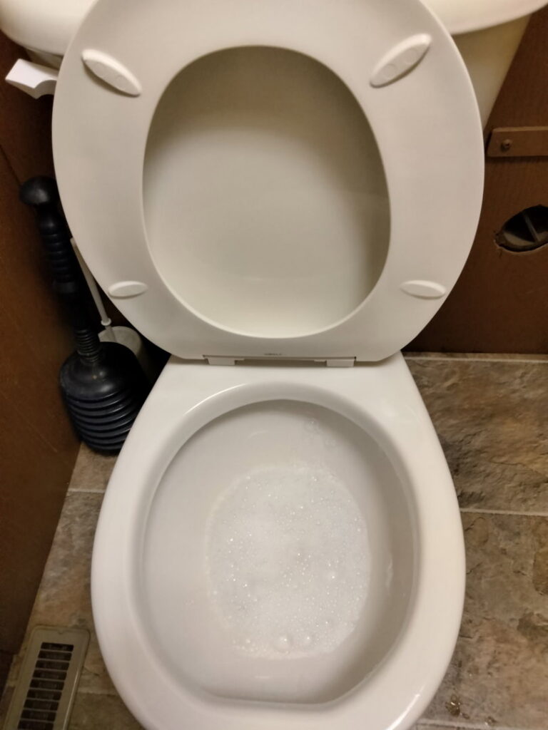 A clean toilet bowl with fresh bubbles, showing the results of a thorough cleaning service by CleanSlate Cleaning Company in Lansing, MI.