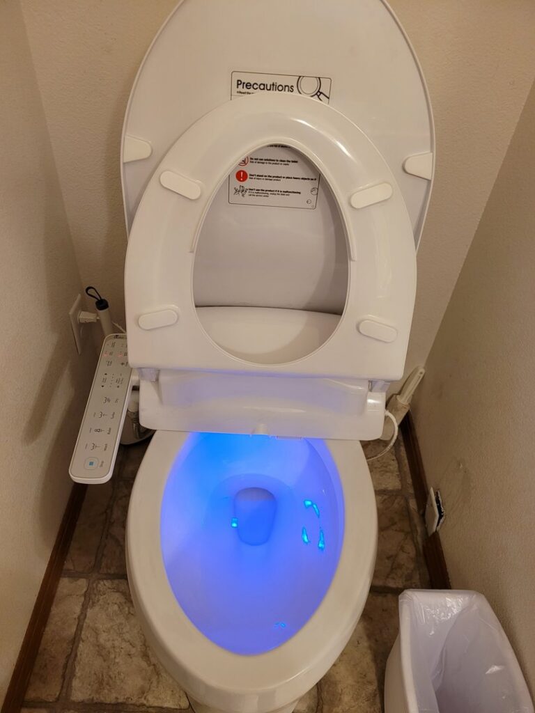 A clean toilet with a modern bidet attachment after housekeeping service from Ady's Housekeeping in Yakima, WA