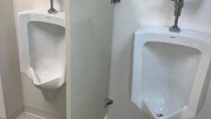 Two sparkling clean urinals in a commercial restroom, maintained by West & Co Cleaning Services in Laurel, MD