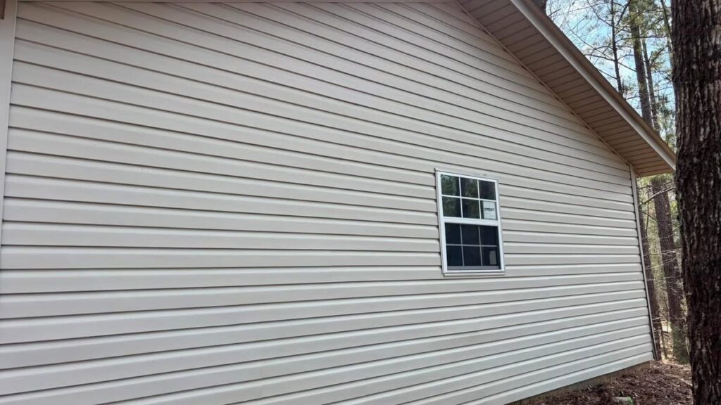 Clean light-colored vinyl siding on a house after professional washing by Plains Power Washing in Auburn, AL.