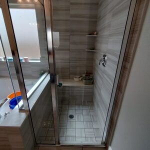 A pristine walk-in shower with tiled walls and floor, showcasing the excellent cleaning by Rita's cleaning in Fort Worth, TX.