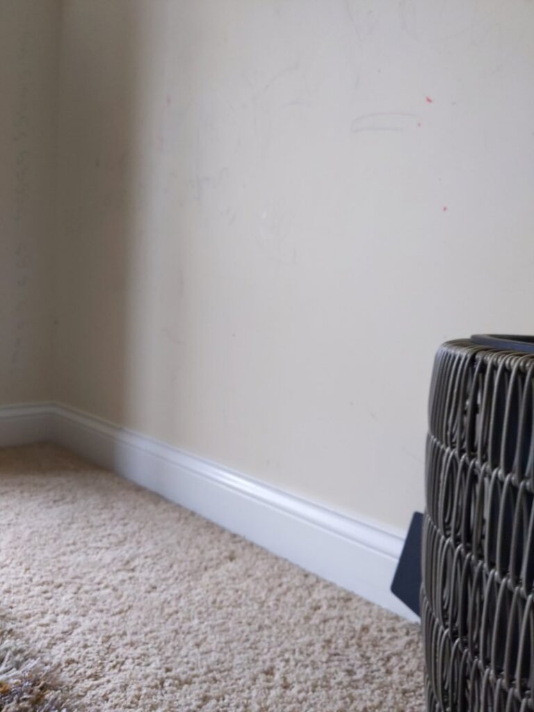 A clean white baseboard and wall, showcasing attention to detail by Chelle's Cleaning Services in Gary, IN.