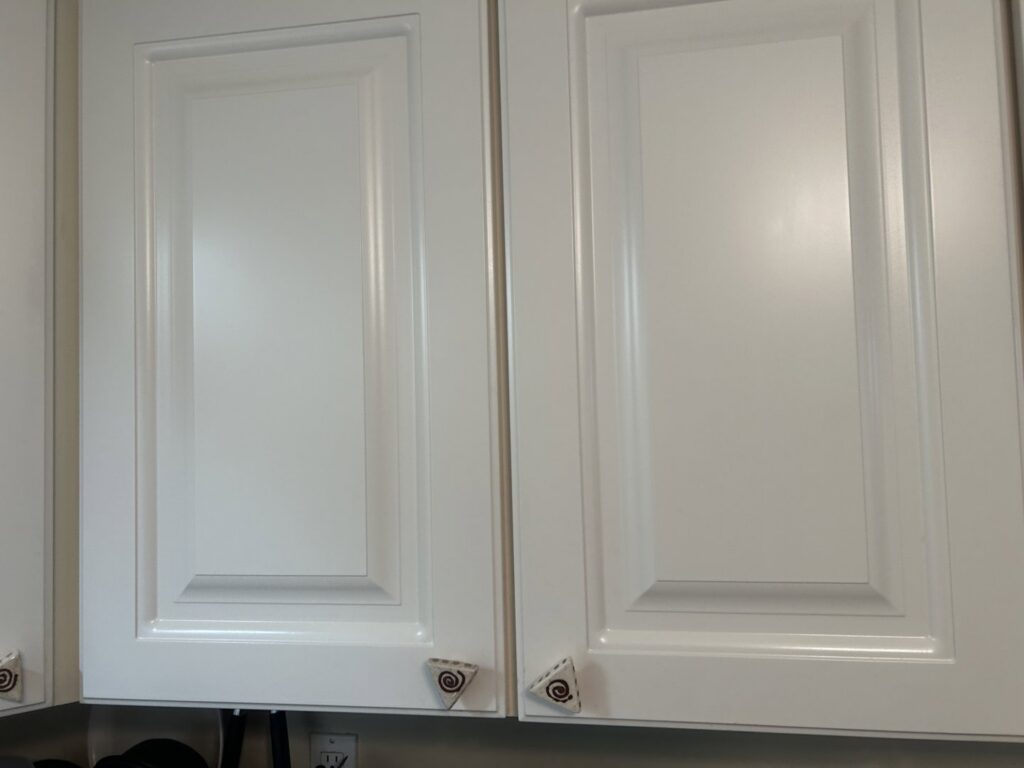 Clean white kitchen cabinets, showing the polished finish achieved by Wilkie Wonders Cleaning in Akron, OH.