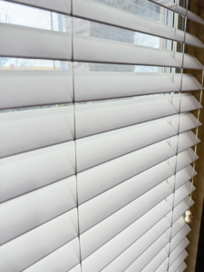 Sparkling clean window blinds in a home, showcasing the results of Caro's Pro Cleaning Services in Orem, UT.