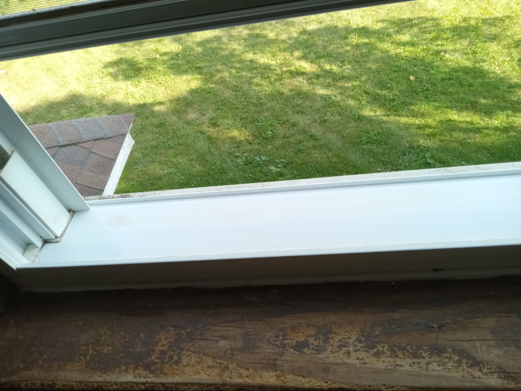 A sparkling clean window frame and sill, showcasing the excellent results of house cleaning by Sparkle & Shine of Iowa in Urbandale, IA.