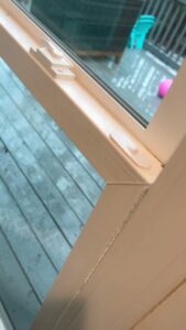 A close-up of a sparkling clean window frame and glass, showcasing attention to detail by Royal Madam Cleaning LLC in Charlotte, NC.
