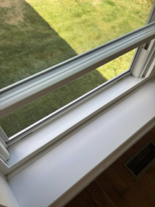 A clean window sill and frame after professional cleaning by Tidy Townhouses in Manchester, NH.