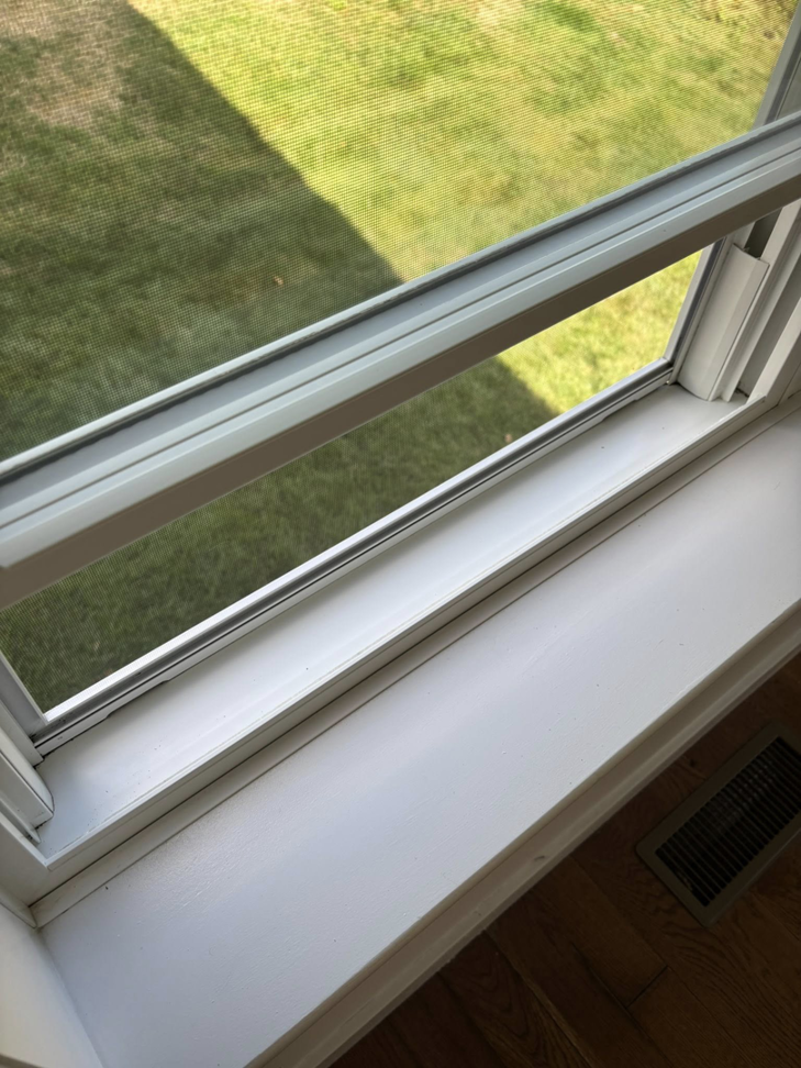 A clean window sill and frame after professional cleaning by Tidy Townhouses in Manchester, NH.