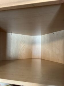 A meticulously cleaned wooden cabinet interior by Whole New World Cleaning Service, LLC in Wilmington, DE
