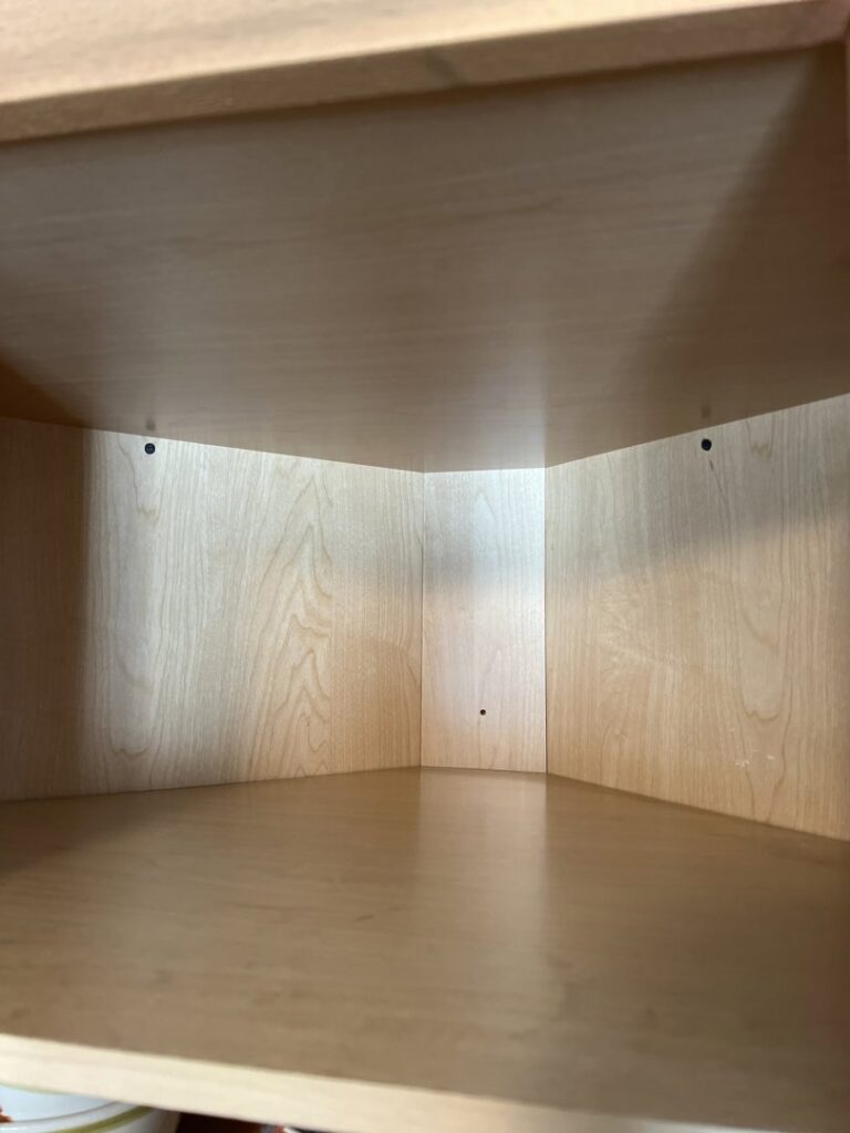A meticulously cleaned wooden cabinet interior by Whole New World Cleaning Service, LLC in Wilmington, DE