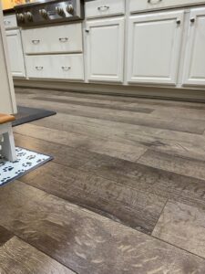 A close-up view of a meticulously clean wooden floor in a kitchen, highlighting the detailed cleaning services provided by CleanCo Works in Scottsdale, AZ.