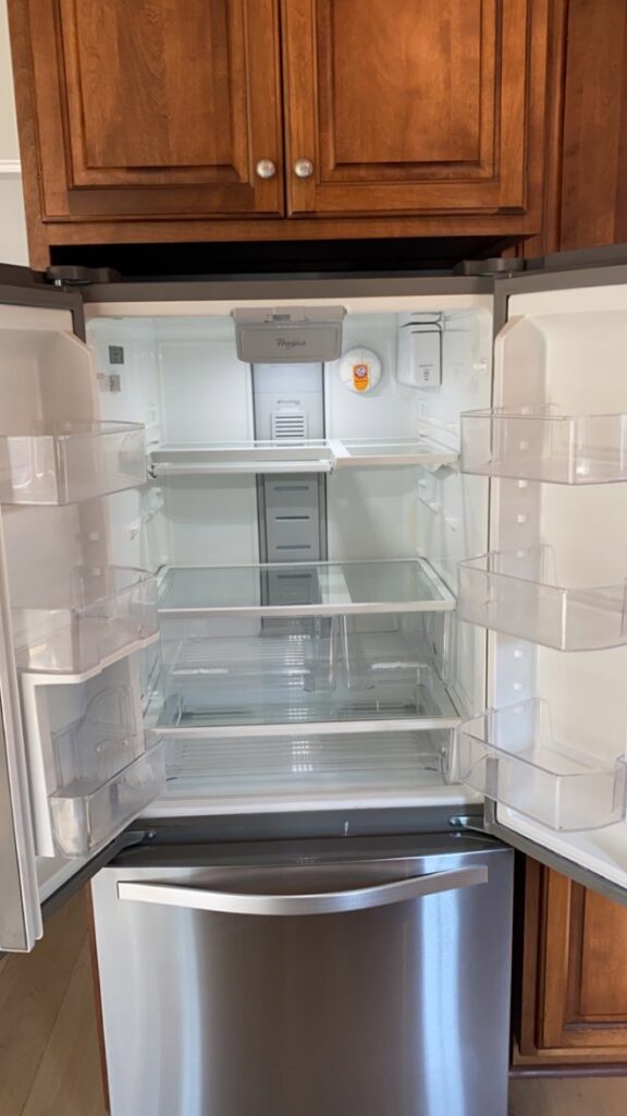A sparkling clean and empty refrigerator, showcasing professional appliance cleaning by Everest Cleaning LLC in East Peoria, IL