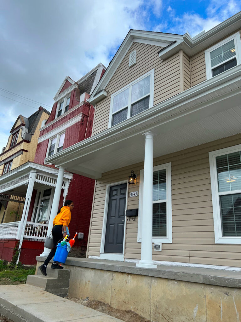 A cleaner from Gem City Commercial and Residential Cleaning arriving at a residential house with cleaning supplies in Dayton, OH