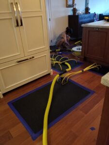 A cleaner from RK Cleaning Services performing deep wood floor cleaning in a Fort Lauderdale, FL residence.