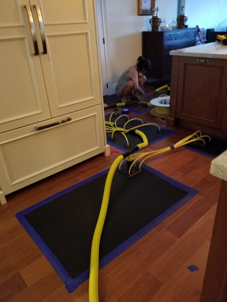 A cleaner from RK Cleaning Services performing deep wood floor cleaning in a Fort Lauderdale, FL residence.