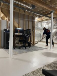 A cleaner from Bivian's Cleaners LLC mopping a freshly cleaned basement floor in Trenton, NJ.
