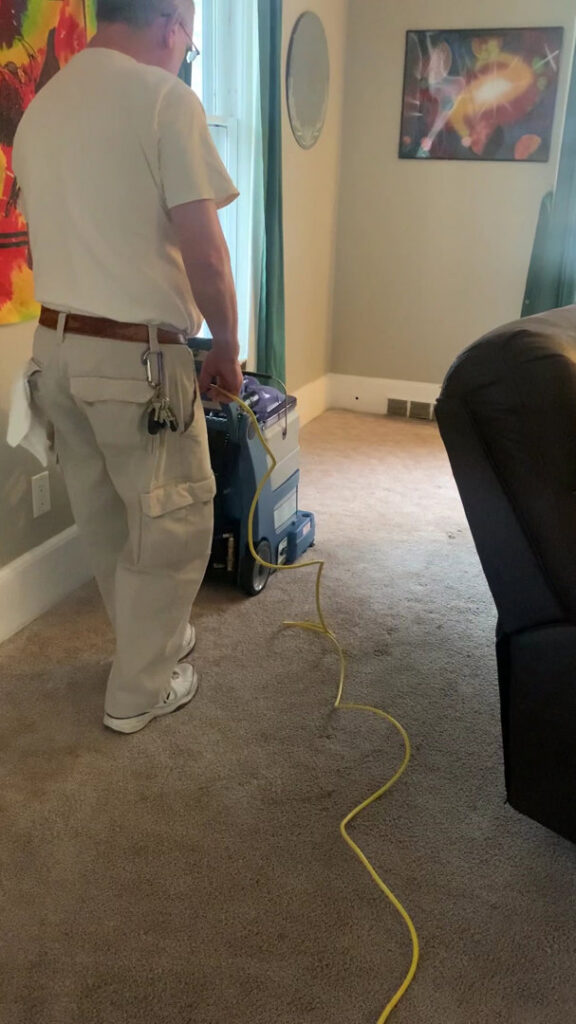 A professional cleaner operating a carpet cleaning machine in a home by K & L Cleaning Services in Pelzer, SC.