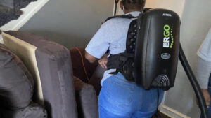 A professional cleaner using an Atrix Ergo backpack vacuum cleaner for Statewide cleaning services llc in Philadelphia, PA.