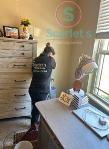A professional cleaner vacuuming a bedroom carpet, providing house cleaning services by Scarlet Cleaning Service LLC in Bronx, NY.