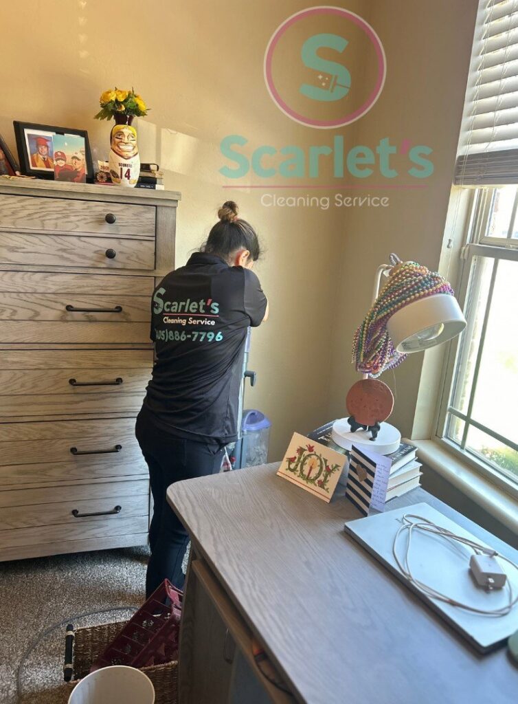 A professional cleaner vacuuming a bedroom carpet, providing house cleaning services by Scarlet Cleaning Service LLC in Bronx, NY.