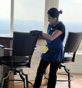 A cleaner from Fabylous Cleaning Service wiping a bar stool in a home in Anaheim, CA.