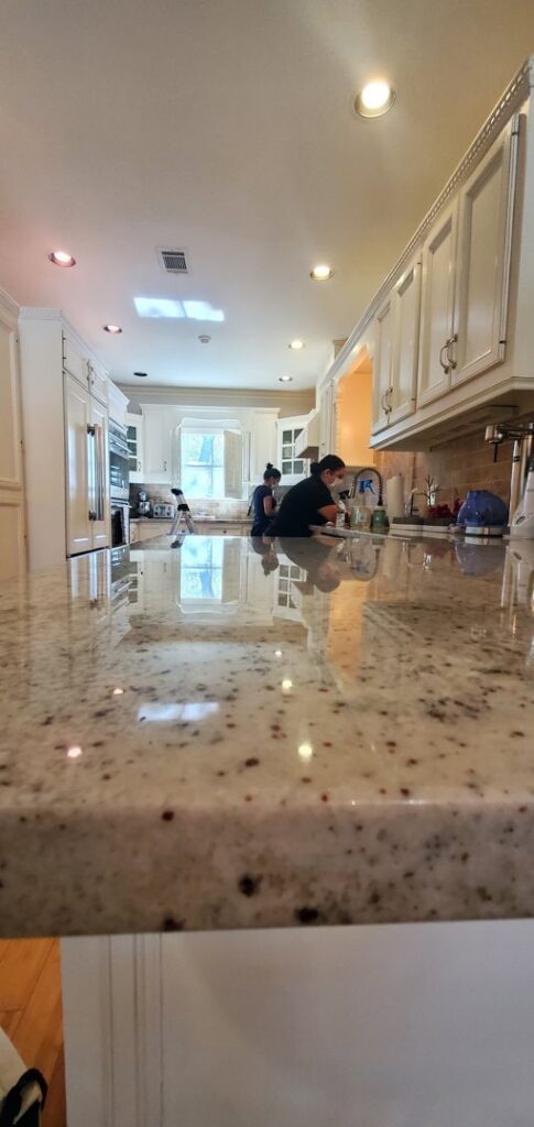 Professional cleaners working in a kitchen, providing house cleaning services by Rubber Gloves Residential Cleaning in San Antonio, TX.