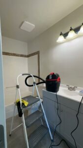 Professional cleaning equipment, including a shop vac and ladder, set up for a deep clean in a bathroom by Cleaning Quality in Sturgis, SD