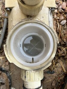 A person cleaning a hot tub or spa with a hose, part of the comprehensive services offered by Aloha Pool Cleaning LLC in Las Vegas, NV.